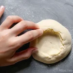 홈베이킹 반죽 숙성 시간 - ** A pair of hands (gender-neutral, wearing a simple wedding band or no jewelry) delicately performi...