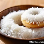 홈베이킹 찹쌀도넛 만들기 - A close-up image of a freshly made glutinous rice donut with a golden-brown crispy exterior and a so...