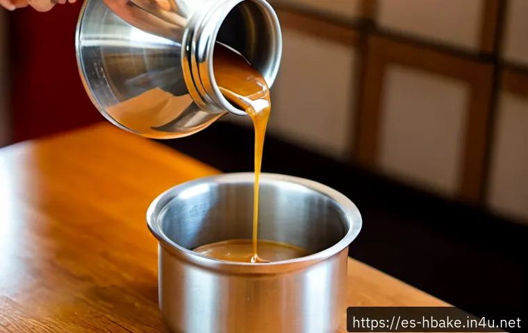 홈베이킹 카라멜 소스 만들기 - Photorealistic close-up of homemade caramel sauce being slowly poured from a small stainless-steel s...